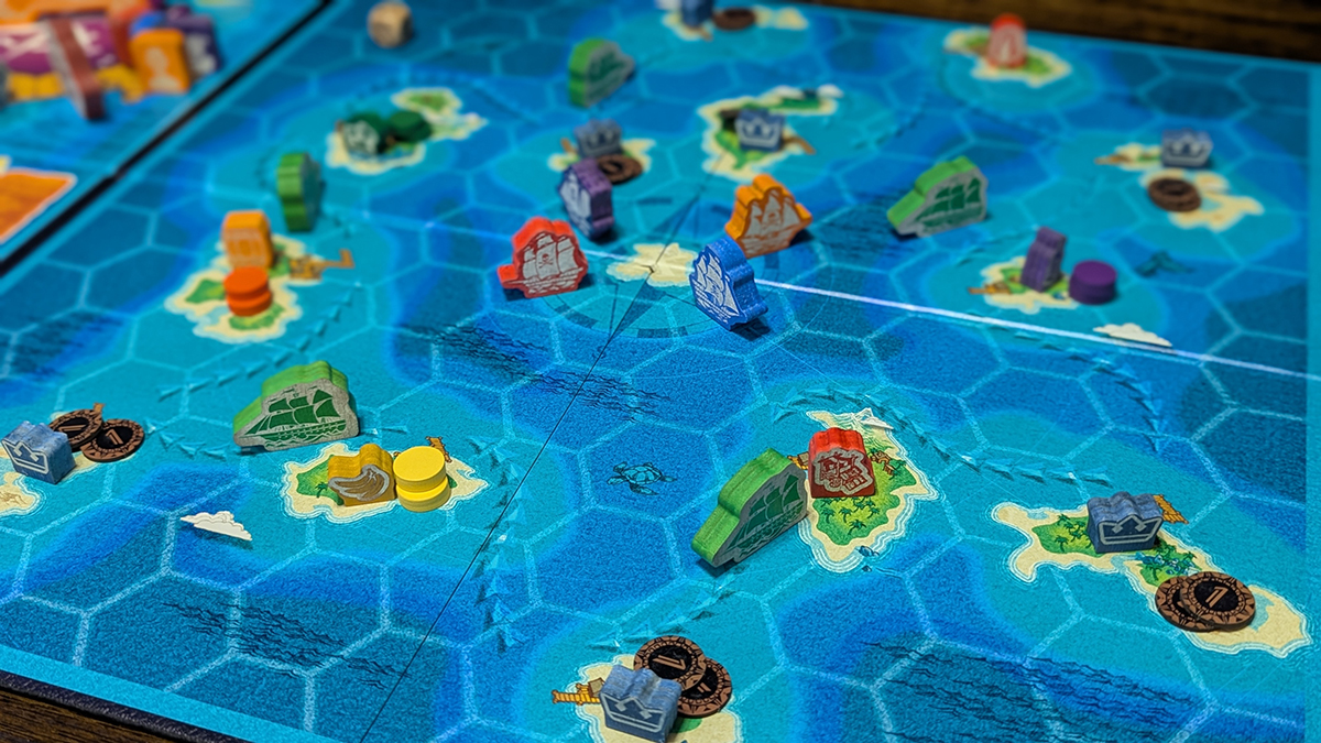 Overview of the game board with player ships, resources and islands on top of a hex grid.