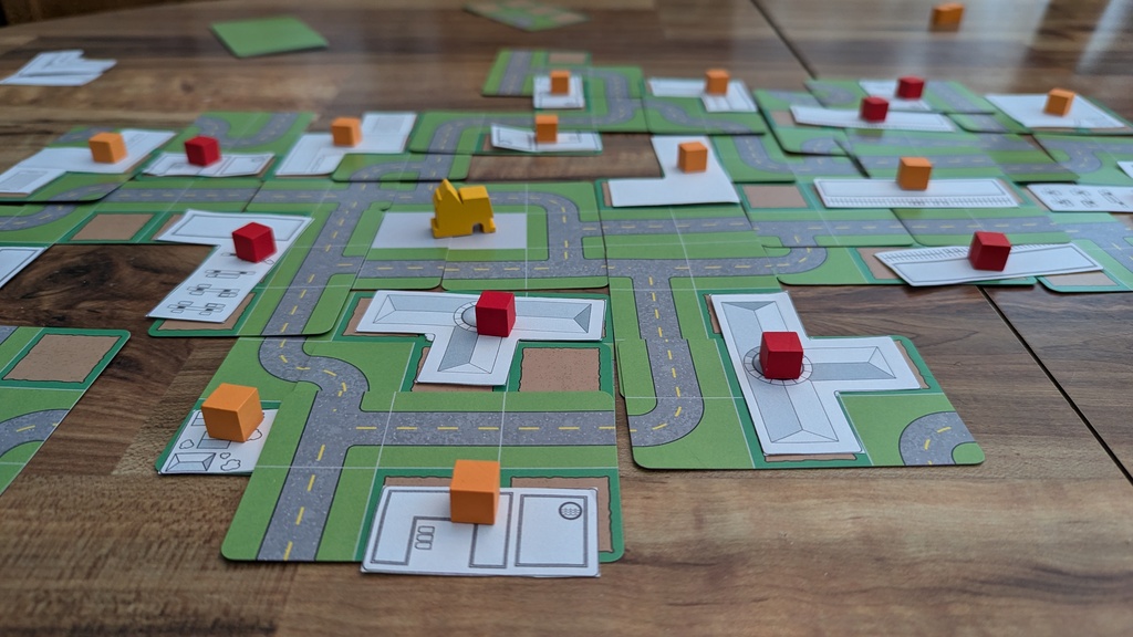 Close up image of the cards and tiles with cubes on top of the building tiles.